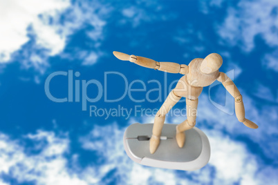 Composite image of 3d image of carefree wooden figurine standing on computer mouse