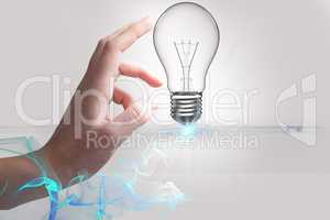 Hand touching a bulb light in white background