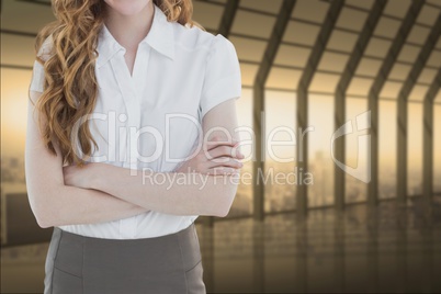 business woman with arm crossed in a corridor