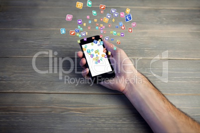 hand showing icons holograms on the screen of a smartphone against wooden background