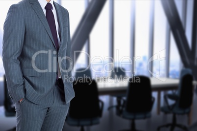 businessman is holding hands in the pockets against meeting room background