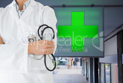 doctor model is holding stethoscope against pharmacy background