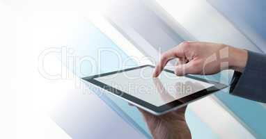 Businessman touching tablet with diagonal striped background