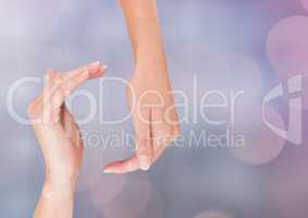 Hands in curved posture with sparkling light bokeh background
