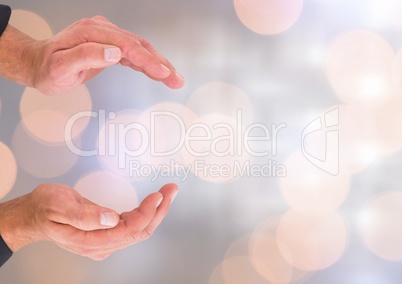 Hands holding invisible space with sparkling light bokeh background
