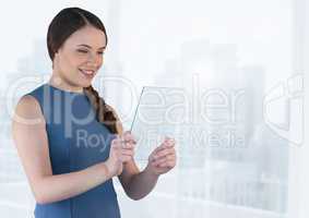 Businesswoman holding glass screen with bright background