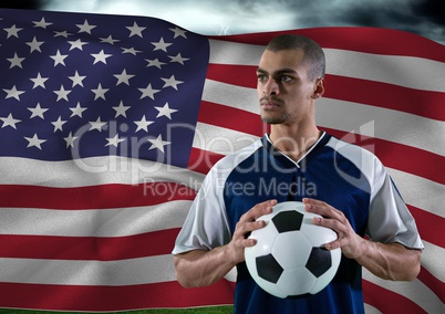 Soccer player with ball on his hand in the field in front of a flag