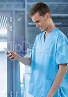 Doctor smiling at mobile phone in modern room
