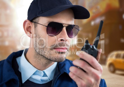 security guard speaking with the walkie-talkie in the street.