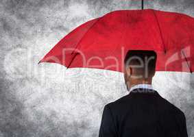 Back of business man with umbrella against white background and grunge overlay
