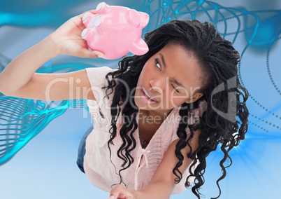 Broke black woman looking on piggy-bank . empty pocket concept. blue and lights background