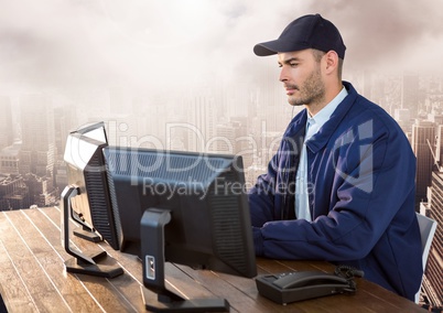 Security man on computer over large city