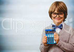 Boy smiling with calculator against blurry blue wood panel