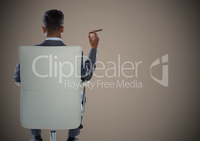 Back of seated business man smoking cigar against brown background