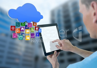 Doctor holding tablet with apps with tall buildings