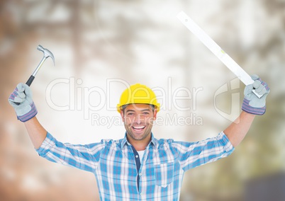 Construction Worker with tools in front of construction site