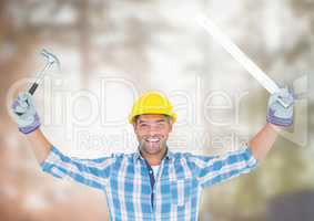 Construction Worker with tools in front of construction site