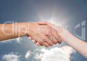 handshake in front of sun