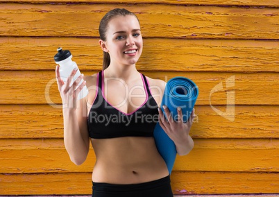 fitness woman, water and yoga mat with yellow wood background