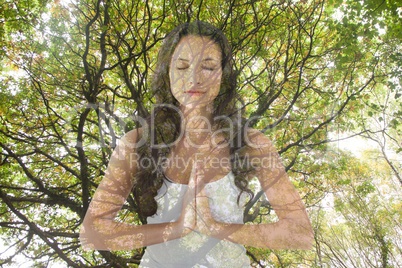 Woman doing yoga under a tree