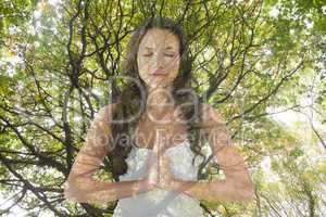 Woman doing yoga under a tree
