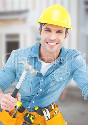 Carpenter with hammer on building site