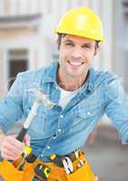 Carpenter with hammer on building site