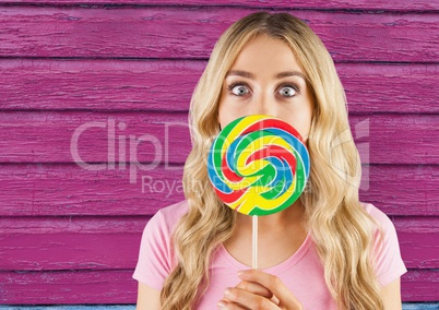 hipster  with lollipop with pink wood background