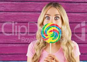 hipster  with lollipop with pink wood background