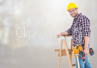 Construction Worker on ladder in front of construction site