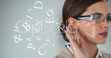 Digital composite image of businesswoman listening alphabets