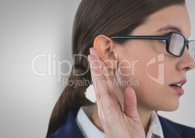 Businesswoman listening gossip against gray background