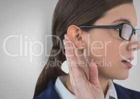 Businesswoman listening gossip against gray background