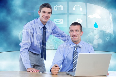 Two businessman using laptop in their office
