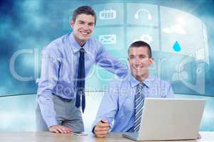 Two businessman using laptop in their office