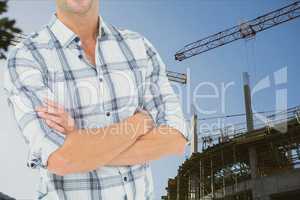 Part of man against crane in construction site