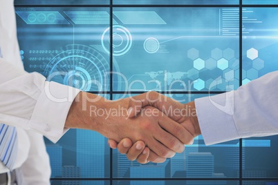 Businessman shaking their hands with a blue digital background