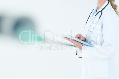 doctor woman is holding a tablet computer against white background