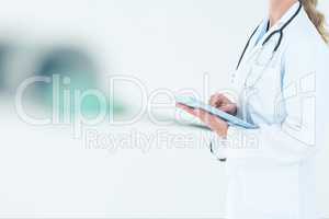 doctor woman is holding a tablet computer against white background