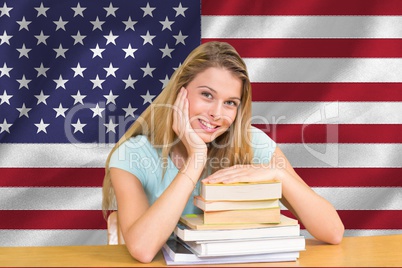 students with elbows on the books against American flag background