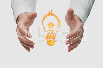 bulb on hands against white background