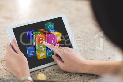 Woman is touching icon on her tablet computer screen