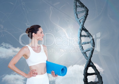 Sporty woman with realistic dna chain against a sky background