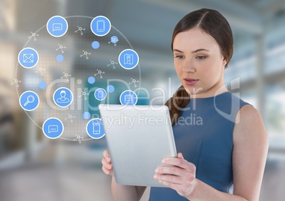 Businesswoman holding tablet with apps icons in bright space hall Businesswoman holding tablet with apps icons in bright space hall