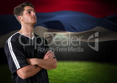 soccer player looking up in the field, with a flag behind