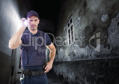 security guard in a alley at night with torch