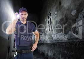 security guard in a alley at night with torch