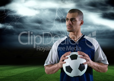 soccer player with ball on his hand in the field. storm