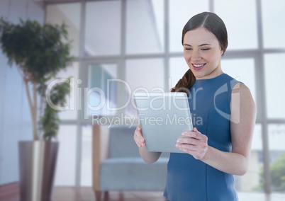 Businesswoman holding tablet in office by window Businesswoman holding tablet in office by window