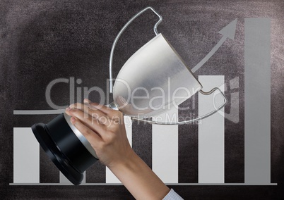 business hand with trophy, blackboard background with graphic